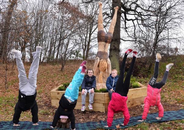 Logans pupils Summer Heard and Patrick Delaney sit this one out as, from left, Mya Gordon, Eve McGugan, Jenna Straub and Carla Mason do handstands.