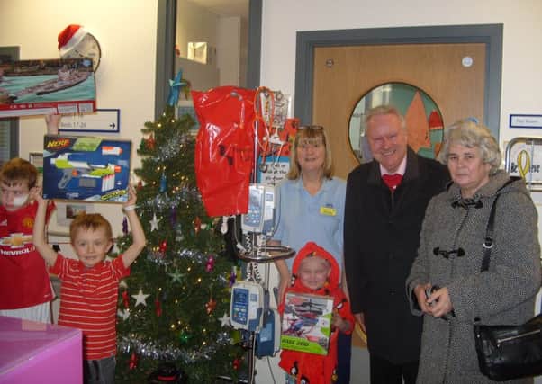 Ray Mitchell and Alex Neil hand over the toys at Glasgow hospital.
