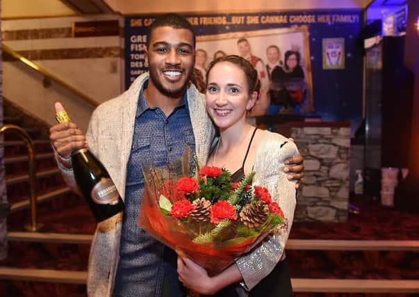 Megan and Kerrence with a bottle of fizz and flowers from staff at The King's Theatre.