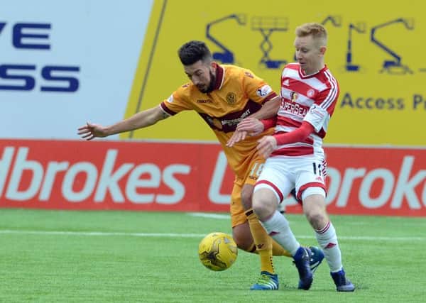 Motherwell's Lee Lucas battles for possession against Hamilton Accies' Ali Crawford last Saturday (Pic by Alan Watson)