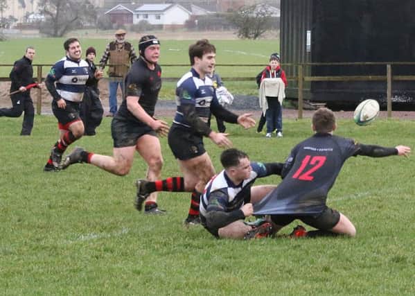 Andrew Jardine attempts to offload to Andrew Orr, both of whom touched the ball down for Biggars second try against Aberdeenshire (Pic by Nigel Pacey)