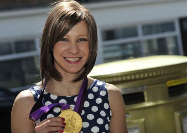 Joanna  Rowsell Shand at the post box painted gold in honour of her gold medal at the olympics 2012. Pic: Chris Gray