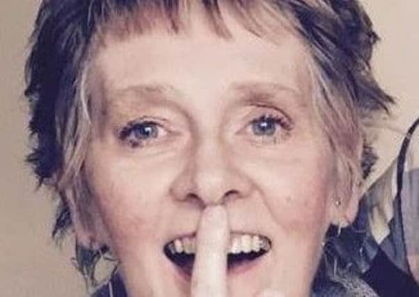 English teacher Liz Ogg - touches her nose - this is something that people with motor Neurone Disease can struggle to do.