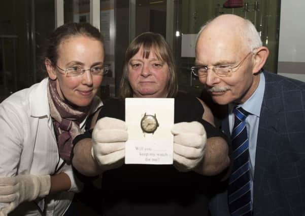 Cath Muir from Newarthill holds her grandfathers watch flanked by curator Emily Malcolm and Sidneys nephew Dr Ernie Worrall. Pic: Craig Foy/SNS Group