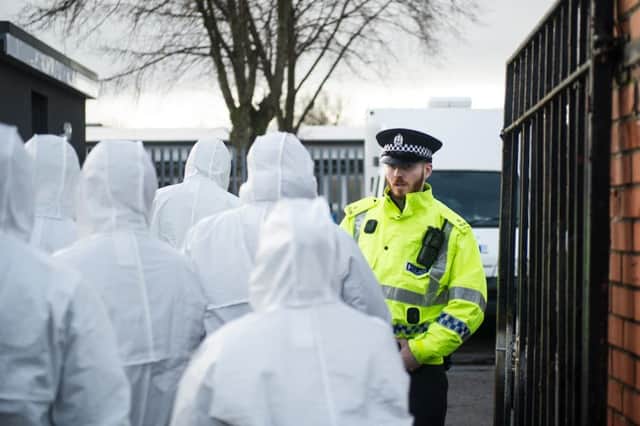 Forensic invesitgators entering the primary school. Picture: John Devlin/TSPL