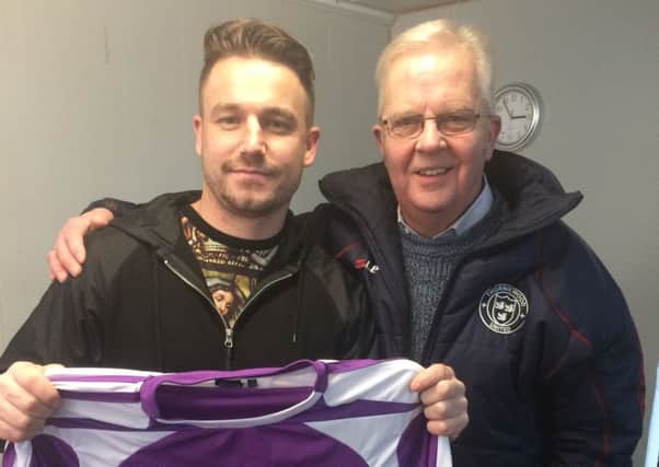 New signing Keigan Parker is welcomed to the club by Thorniewood United president John Miller.