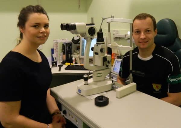Referee Willie Collum with optician Alison Nee at Specsavers in Motherwell