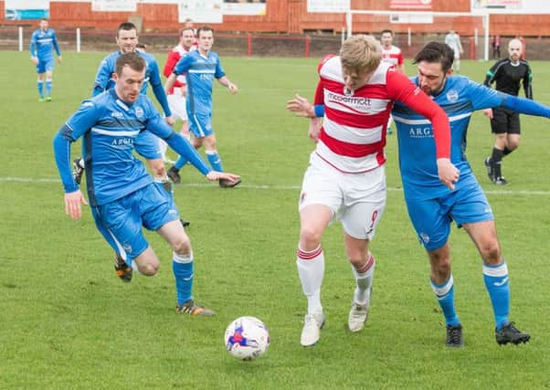 Bonnyrigg's Keiran McGachie shields the ball from Michael McGee and Paul Doyle.