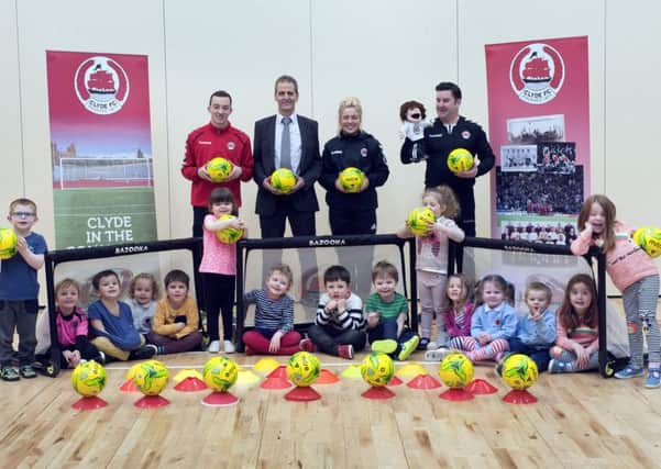 Clyde FCs Tom Elliott, Cara McBearty and Cameron Cairney and sponsors representative David Wilson with happy nursery pupils.