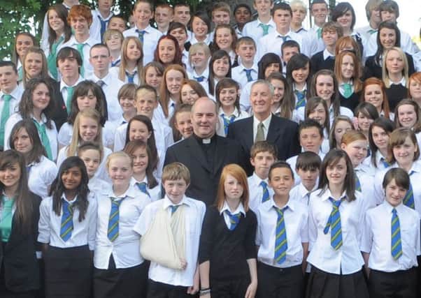 Monsignor Peter Smith is seen here with pupils at his old secondary school Our Lady's High School