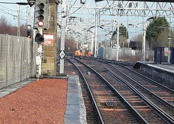 Workmen looking at signal problem at Motherwell station