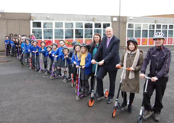 Primary 4 pupils are scoot and aboot at Woodhill with acting principal teacher Allison Kelly, Councillor Alan Moir, class teacher Lisa Horn and Donald Macdonald.