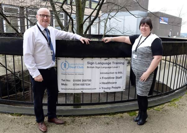 Sign of the times...Ian Galloway and Helen Penman, of Lanarkshire Deaf Club, are keen for local employers to help by signing up for sign language training.