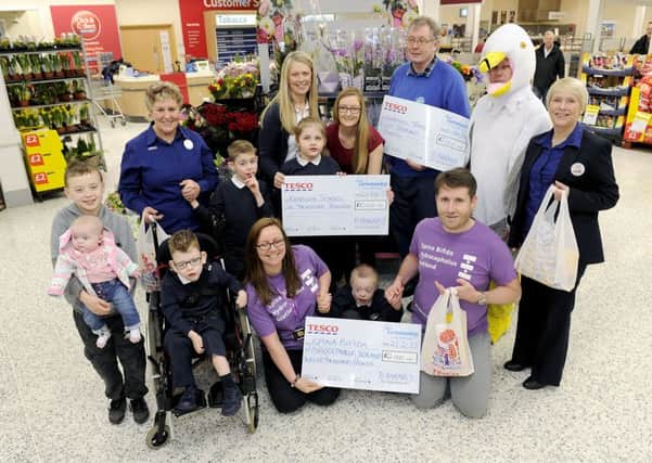 21-02-2017. Picture Michael Gillen. CUMBERNAULD - Tesco Craigmarloch. Representatives from Tesco Craigmarloch, Doreen Reid, community champion and Tesco Kirkintilloch, Leslie Currie, community champion presents cheques to Seagull Trust Kirkintilloch, Â£8000, Redburn School Â£10000 and SBH Scotland Â£12000. Bags of Help, local community grant scheme where the money raised from the 5p bag charge is used to fund local projects in the community.