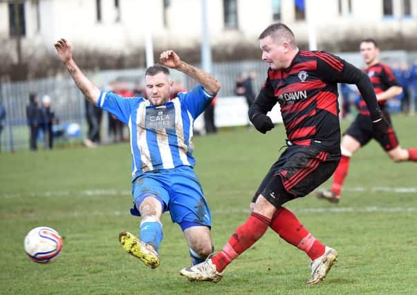 Rob Roy striker Willie Sawyers shoots for goal as Neil Janczyk challenges