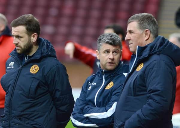 Stephen Robinson (centre) speaks to Mark McGhee during the 5-1 thrashing by Dundee last Saturday. James McFadden is also pictured. (Pic by Alan Watson)