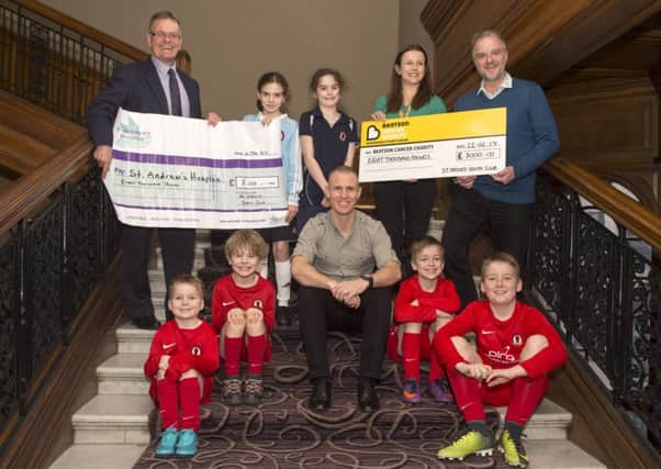 St Cadoc's youth FC  and Kenny Miller hand over 2 cheques  for Â£8,000 each to The Beatson  Cancer Centre and St Andrews Hospice.