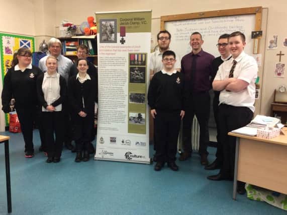 Firpark Secondary pupils with their pop-up banner detailing the story of Victoria Cross winner William Clamp from Craigneuk