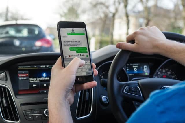 Motorists risk tough penalties if caught using a mobile phone. Pic: John Devlin.