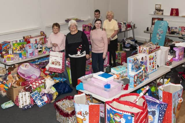 Mary and volunteers with some of the toys which went out to Clydesdale's children at Christmas  ( Picture Sarah Peters.)