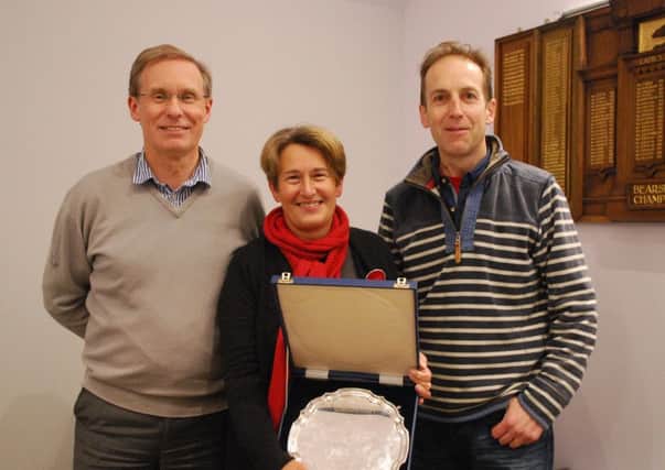 Carol Hamilton receives her trophy from retiring president Paul Thomson (left) and secretary Andy Gordon.