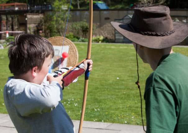 Green Hollow Bowmen archery lesson at Mugdock Country Park. Sunday, May 1 2011. Cameron Clark (10) from Torrance is given a lesson by instructor Gary Nelson. (Photo/Chris Clark) Â© Chris Clark