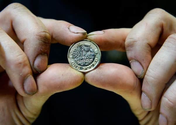 The new Â£1 coin is being produced at the Royal Mint in Llantrisant, South Wales.