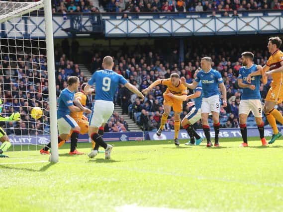 Louis Moult heads Motherwell into an early lead at Ibrox on Saturday (Pic by Ian McFadyen)