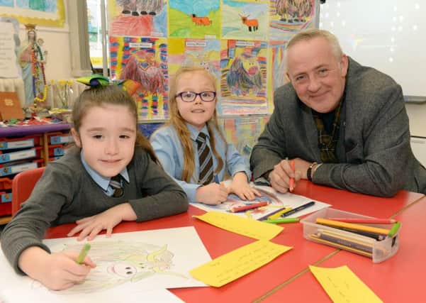 Pupils Caity Reilly and Ruby Pollock with artist Steven Brown