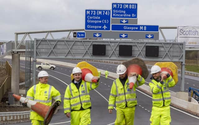 Engineers clear cones from the M8 "Missing Link" as it is set to open ahead of schedule. Pic: SWNS