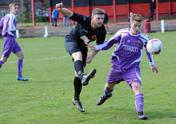 Rossvale man of the match Anton Houghton gets in a shot at the Thorniewood goal