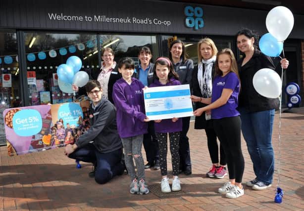 Charity cheque presentation to Lenzie Woodhead Gymnastics, Luisa Hunter, Kerry Hunter, Jacqui Cotton and Scott McKenzie, Co-Op, and kids , trainers from LWG