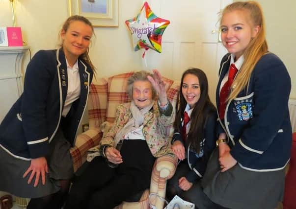 Flo Smith celebrated her 108th birthday - she is here with pupils from her former school.