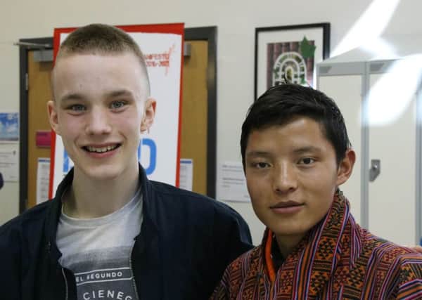 Reece Harding, left, with a member of the Bhutan party.