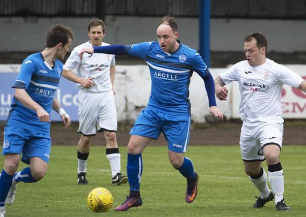 Scott Davidson, later red carded, tries to find a way through the Girvan defence.
