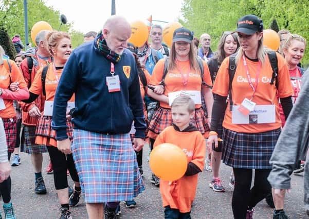 Sir Tom Hunter and lead walker six-year-old Nathan Mowat with mum Gill
