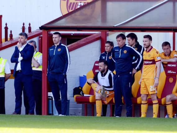 Motherwell manager Stephen Robinson, his backroom staff and 'Well players survey the scene from the Fir Park dugout (Pic by Alan Watson)