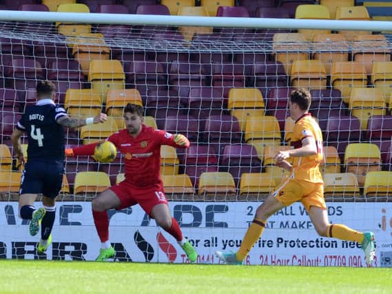 Ross County's Chris Routis shoots the only goal of the game past Motherwell goalkeeper Russell Griffiths (Pic by Alan Watson)