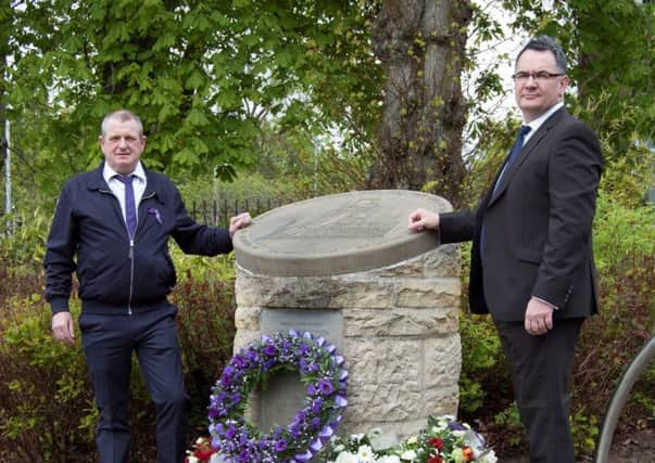 Council chief executive Gerry Cornes is pictured at the cairn with Gerry Malon, who spoke on behalf of the workers.