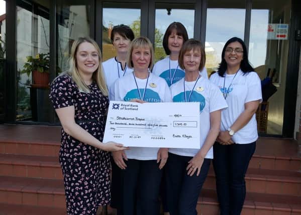 The Boots Kilsyth team present their Bubble Rush cheque to Claire Macdonald of Strathcarron Hospice