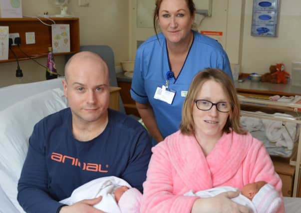 Cheryl McNulty and Scott Wright with their baby daughters and charge midwife Alison Stark