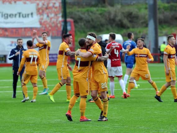 Craig Clay celebrates with Motherwell team-mate Lionel Ainsworth after the vital 1-0 victory at Hamilton Accies (Pic by Alan Watson)