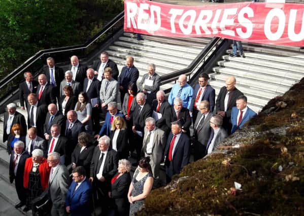 Protestors unveil a 'Red Tories Out!' banner as the official North Lanarkshire Council photograph is taken, which the SNP refused to attend