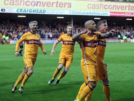 Keith Lasley (1st left) rushes in to congratulate Lionel Ainsworth (2nd right) after his wonder goal against Kilmarnock (Pic by Alan Watson)