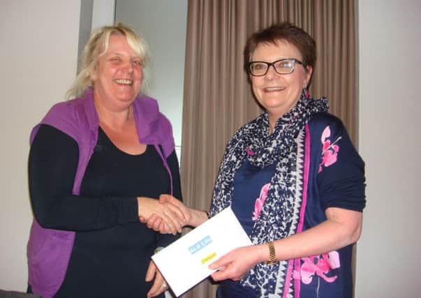 Jean presents the cheque after the fundraiser.