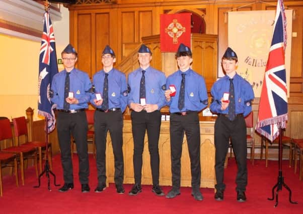 Queen's Award is presented to five young men.