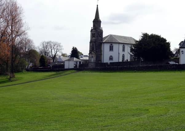 Eaglesham Parish Church with part of the grassed over Orry in front.