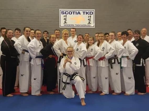 Alex Marshall (front) celebrates with her Scotia Taekwon-do team-mates after arriving back in Carluke following her European title success in Bulgaria (Submitted pic)