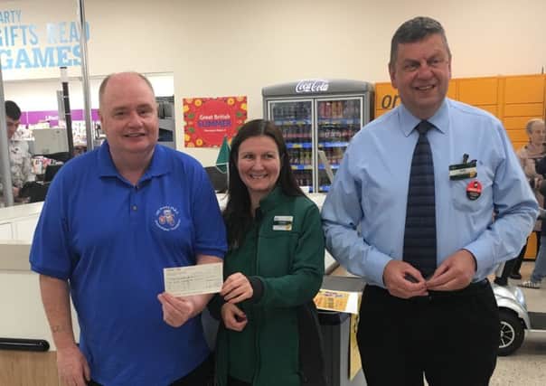 Heather Johnston with Les Hoey and Morrisons Bellshill customer services manager Andy Robb