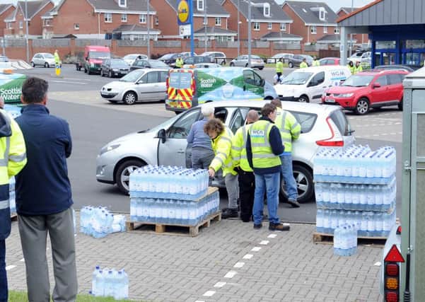 Householders had to queue for water at collection points, including this one at the Lidl store in New Stevenston, after being warned their supplies were unfit to drink
